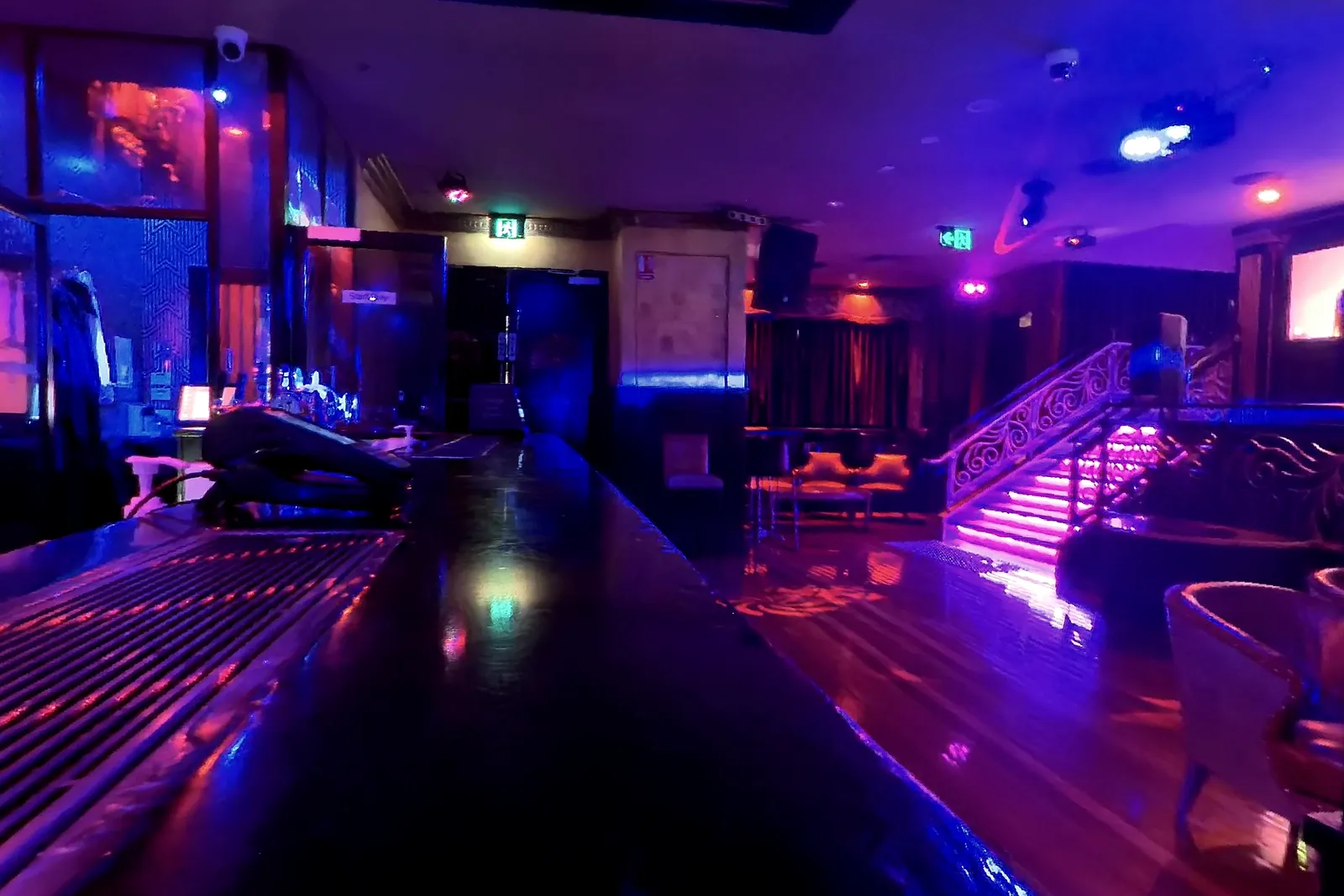 The entrance end of the main floor, with the lit staircase